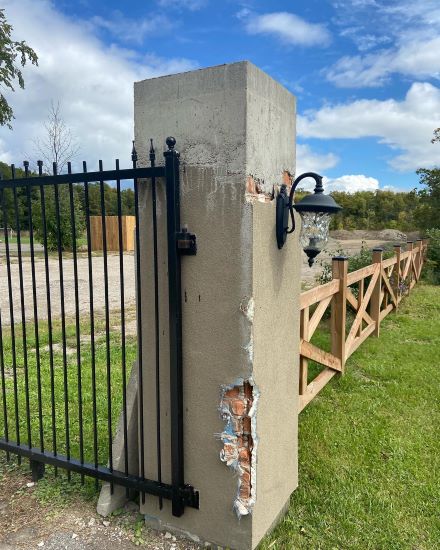 A cracked and damaged stucco wall.